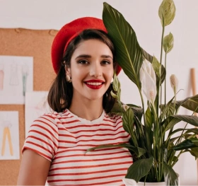 A girl carrying a plant